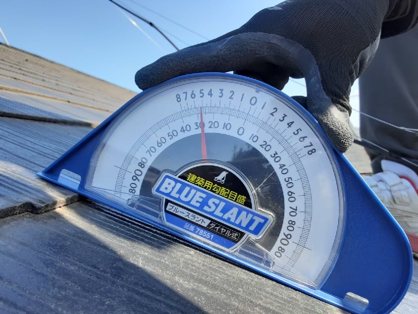 屋根勾配を確認するスタッフ